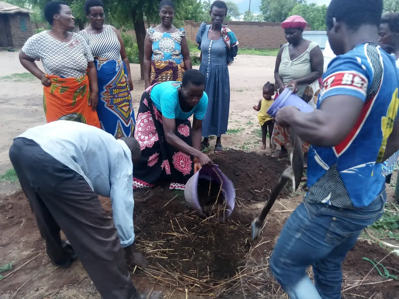 Community participants preparing organic material during a practical demonstration