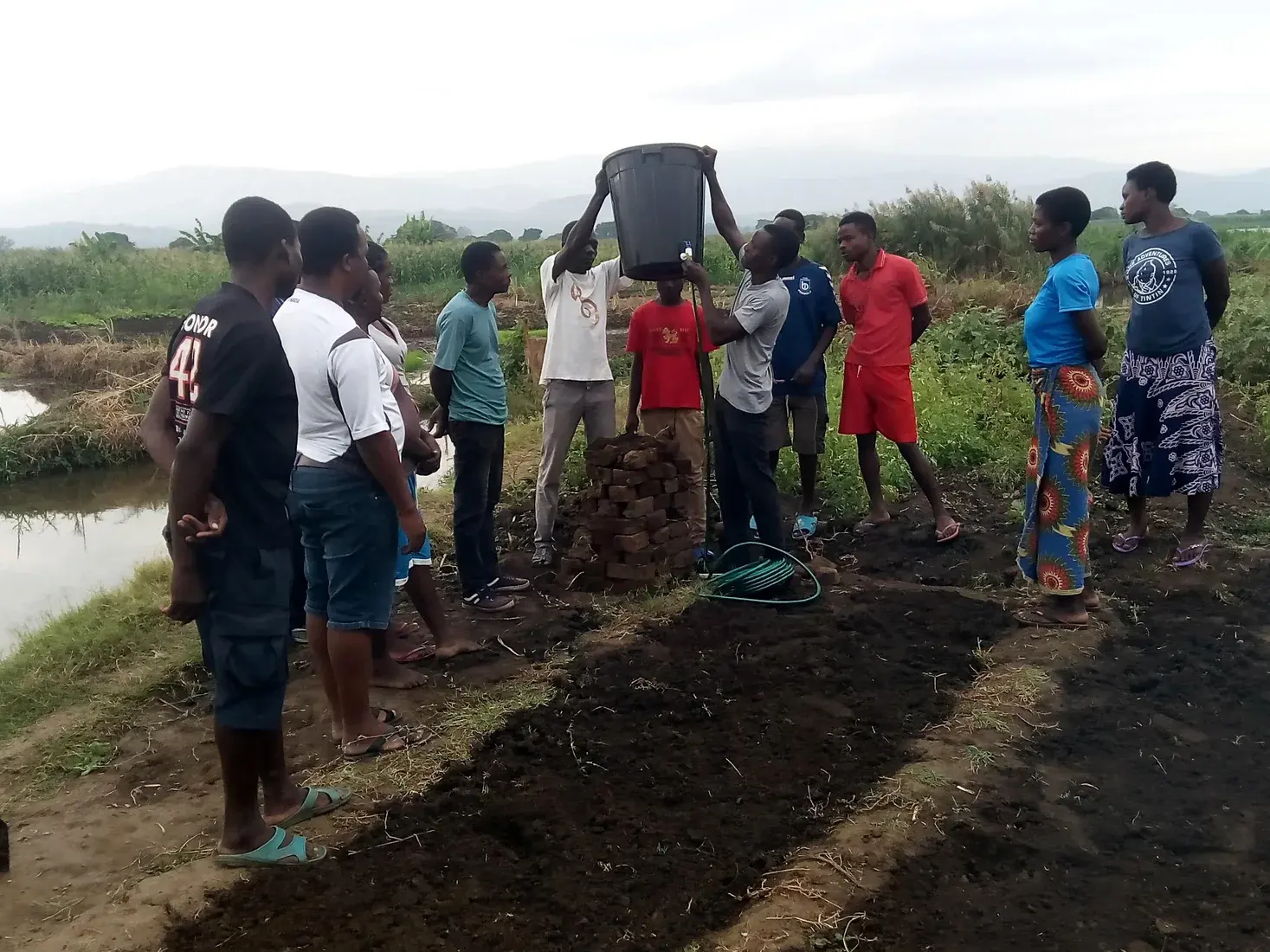 Women and men participating together in a practical livelihood-learning activity