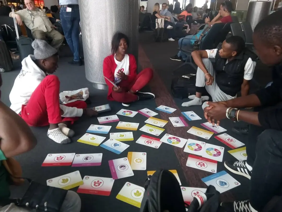 Young adult participants using visual learning cards during a collaborative workshop