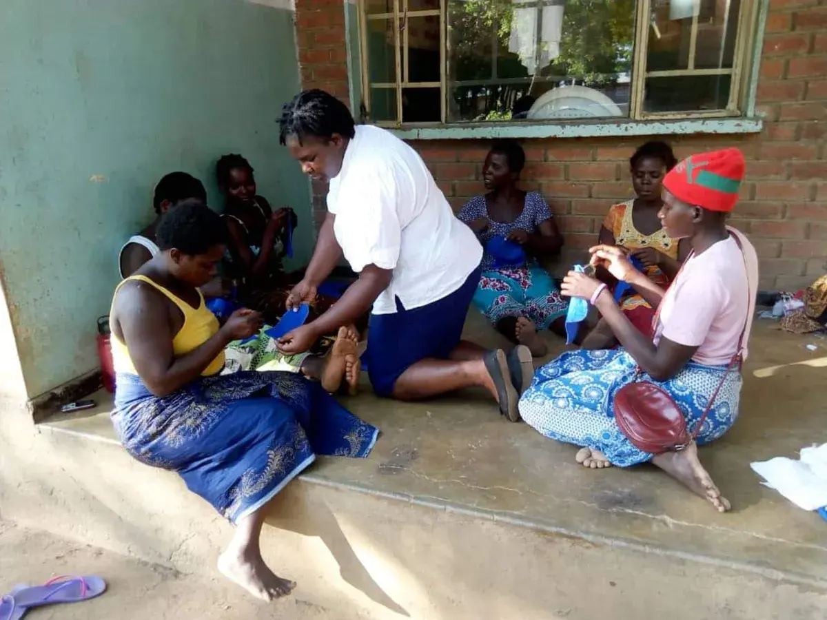 Women participating in a practical livelihoods and skills activity at a community centre