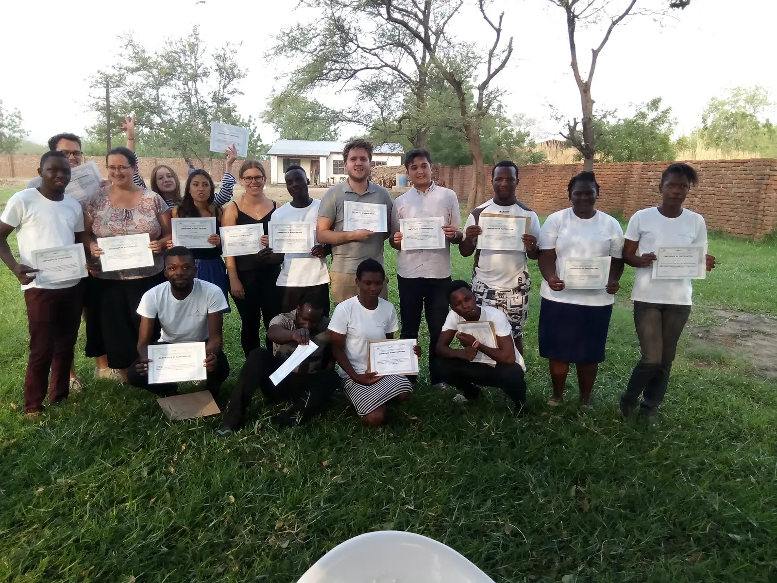 SURCOD participants and volunteers holding certificates after completing a shared learning programme