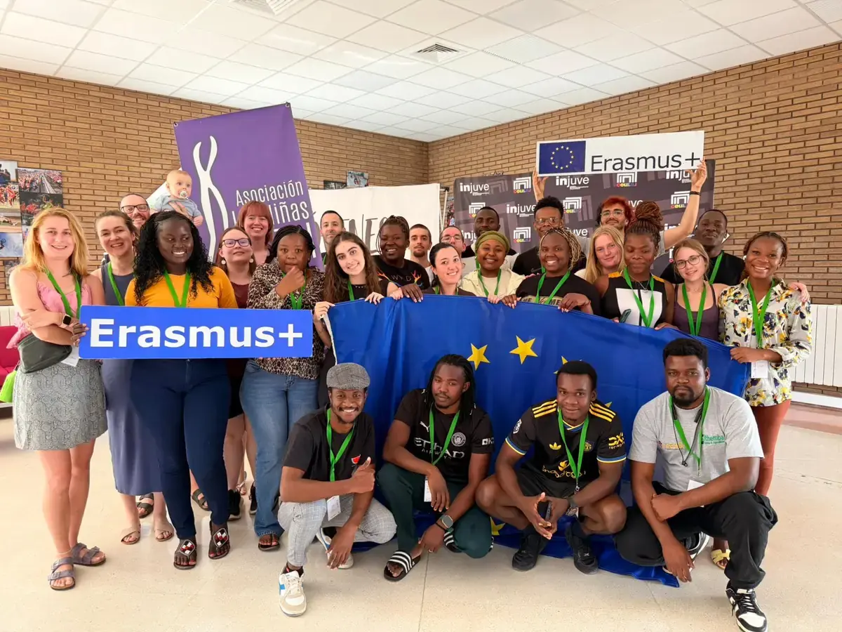 Participants from the Erasmus+ youth exchange gathered behind an EU flag and Erasmus+ sign at CEULAJ in Spain
